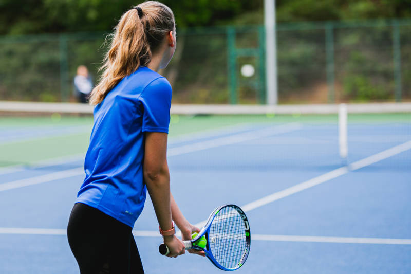 Lady about to serve in tennis