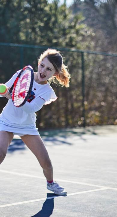 Young girl playing tennis